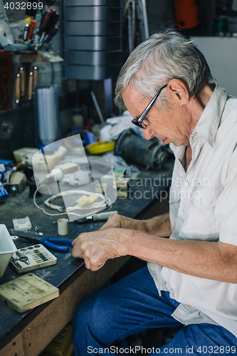 Image of Senior engineer working in garage