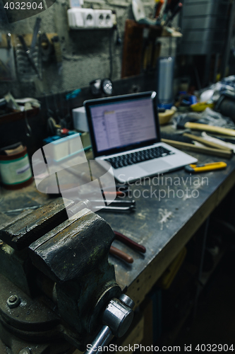 Image of View of old tools,laptop and phone on table