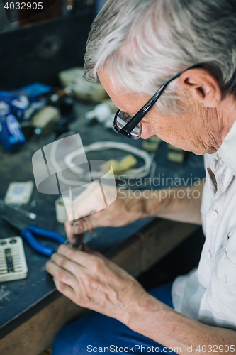 Image of Senior engineer working in garage