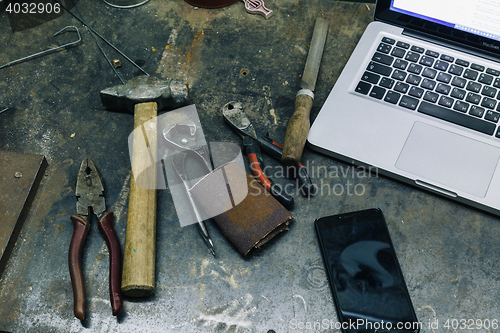 Image of Top view of old tools,laptop and phone on table