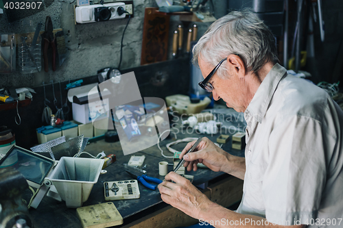 Image of Senior engineer working in garage