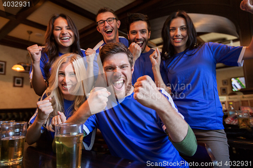 Image of football fans or friends with beer at sport bar