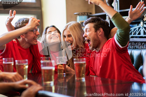 Image of football fans or friends with beer at sport bar
