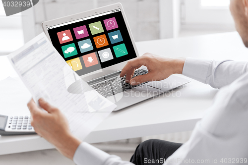 Image of businessman with laptop computer working at office