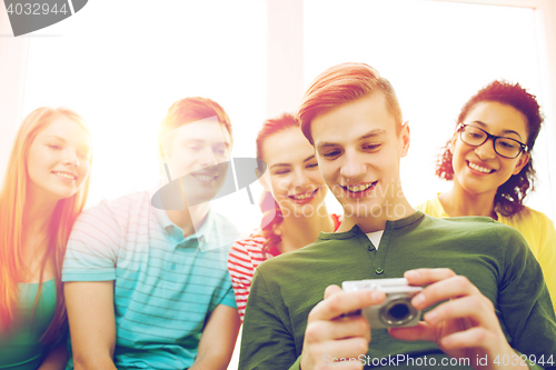 Image of smiling students with digital camera at school