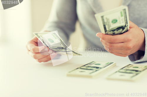 Image of close up of woman hands counting us dollar money