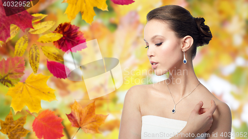 Image of beautiful asian woman with earring and pendant