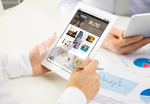 Image of close up of hands with internet blog on tablet pc