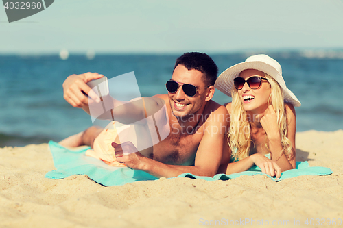 Image of happy couple in swimwear walking on summer beach