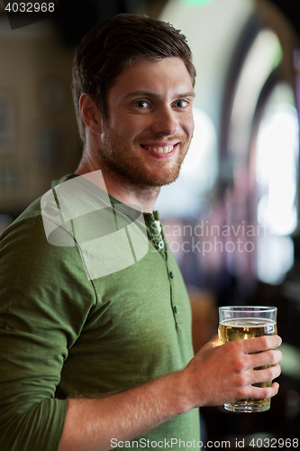 Image of happy man drinking beer at bar or pub