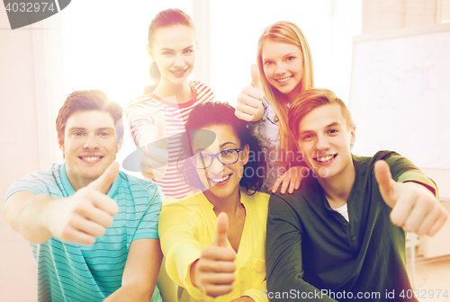 Image of smiling students at school showing thumbs up