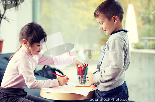 Image of happy little girl and boy drawing at home