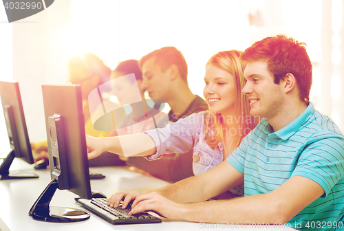 Image of smiling students in computer class at school