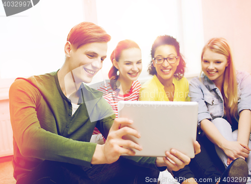 Image of smiling students making picture with tablet pc