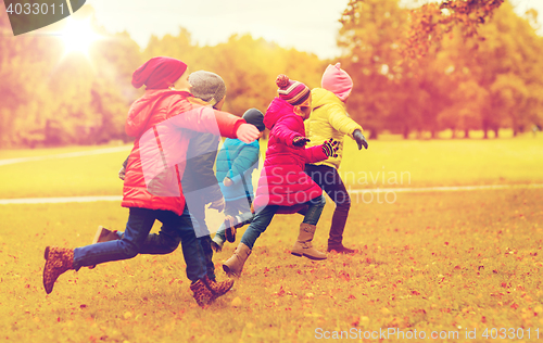 Image of group of happy little kids running outdoors