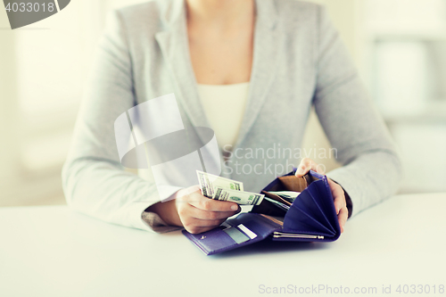 Image of close up of woman hands with wallet and money