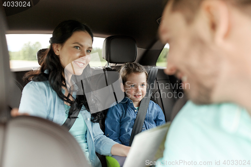 Image of happy family with travel map driving in car