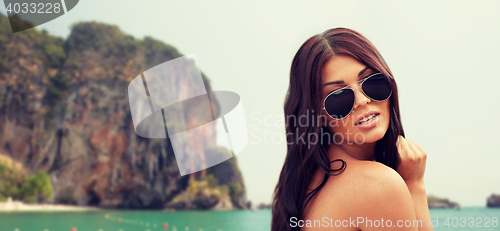 Image of young woman with sunglasses on beach