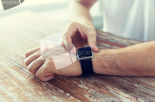 Image of close up of male hands setting smart watch