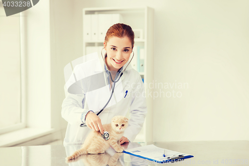 Image of happy veterinarian with kitten at vet clinic