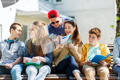 Image of group of students with notebooks at school yard