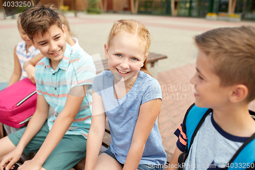 Image of group of happy elementary school students talking