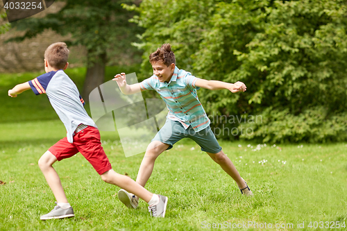 Image of happy kids running and playing game outdoors