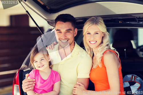 Image of happy family with hatchback car at home parking