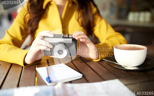 Image of close up of woman with camera at city cafe