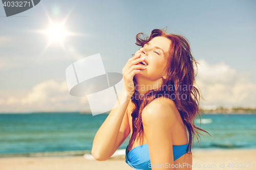 Image of laughing woman on the beach