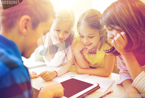 Image of group of school kids with tablet pc in classroom