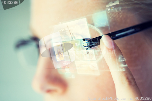 Image of close up of woman in glasses with virtual screen