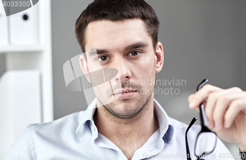 Image of portrait of businessman with eyeglasses at office