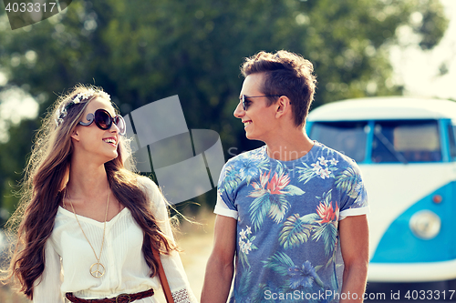 Image of smiling young hippie couple over minivan car