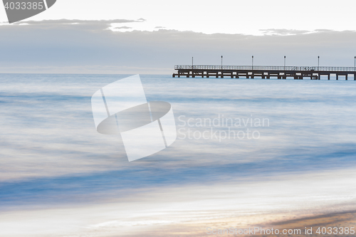 Image of The seashore overlooking the marina after sunset, photographed with a long exposure