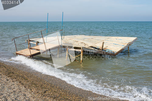 Image of Break a small wooden pier on the seashore