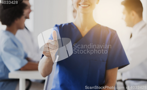 Image of close up of doctor showing thumbs at hospital