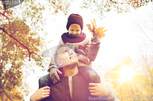 Image of happy family having fun in autumn park