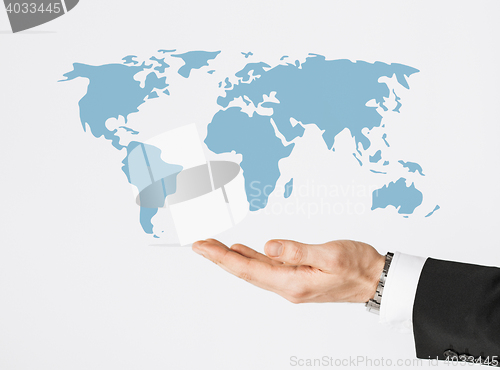 Image of close up of businessman hand showing world map