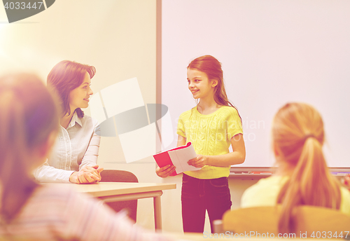 Image of group of school kids with teacher in classroom