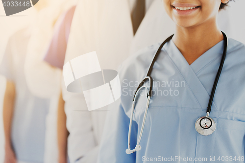 Image of close up of happy doctor or nurse with stethoscope