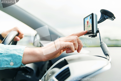 Image of close up of man with gps navigator driving car