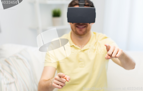 Image of young man in virtual reality headset or 3d glasses