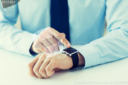 Image of close up of male hands setting smart watch