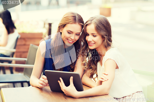 Image of happy young women or teenage girls with tablet pc