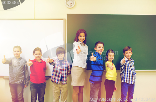 Image of group of school kids and teacher showing thumbs up