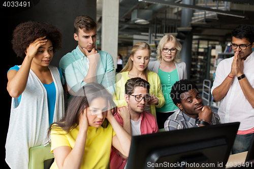 Image of international students with computers at library