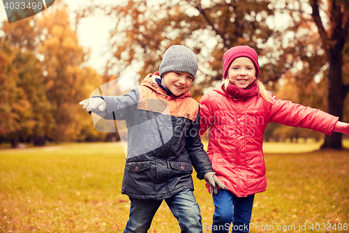 Image of happy little children running and playing outdoors