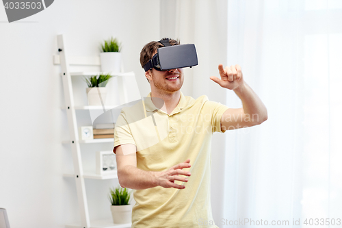 Image of young man in virtual reality headset or 3d glasses