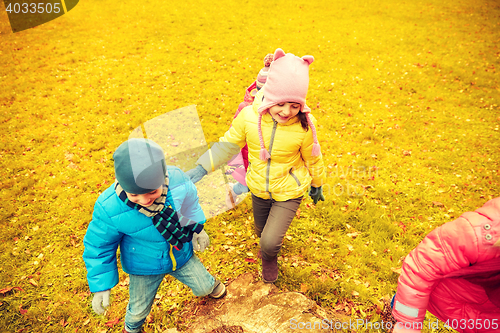 Image of group of happy children having fun in autumn park